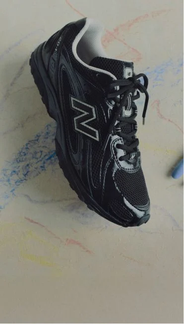 One black 204L shoe in studio.